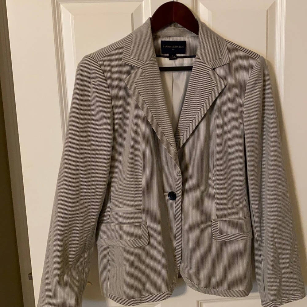 Pinstripe ladies single-breast blazer. Fully lined. 2 flap pockets, coin pocket.